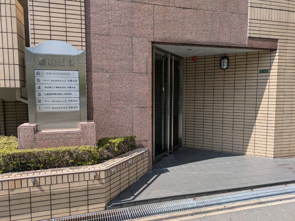 右手に見える茶色の塩山ビル外観
